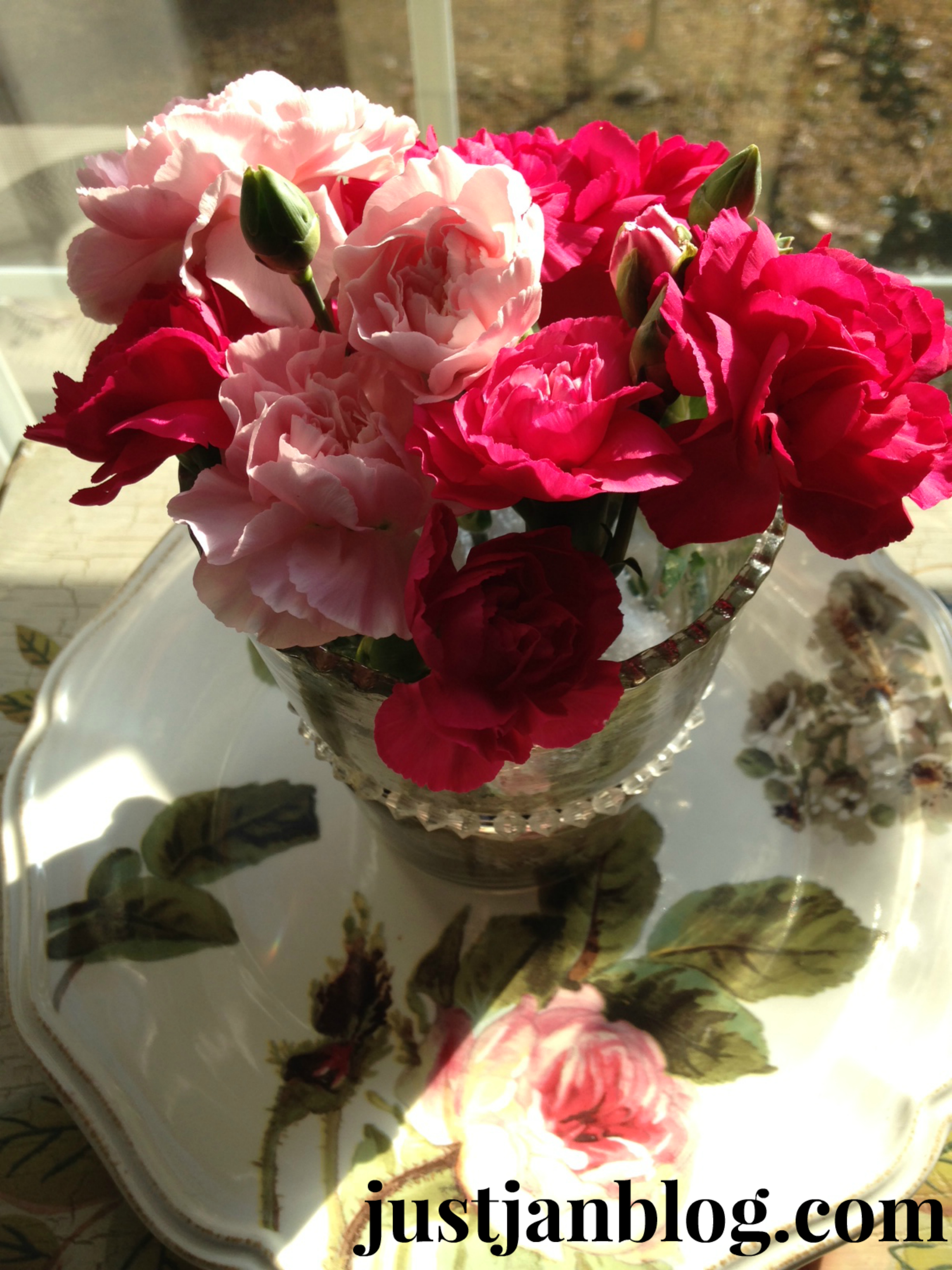 Roses in mercury glass on rosey dish